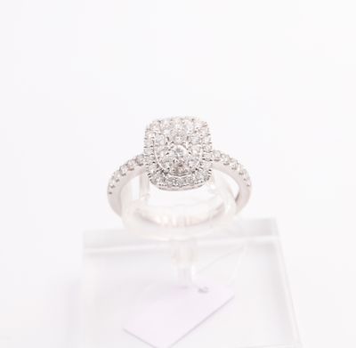 a close up of a diamond ring on a clear display stand