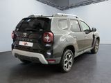 the rear end of a silver suv parked in a garage