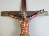 a statue of jesus on the cross on the wall