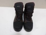 pair of black boots with red laces sitting on a white surface