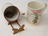 a coffee cup that is sitting next to a miniature bird