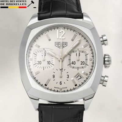 a close up of a watch with a white dial