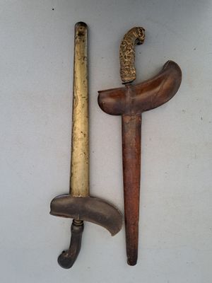 two different types of weapons on display on a table