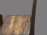 a wooden chair and a wooden table on a grey background