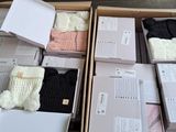 several boxes of clothing are stacked on top of each other