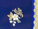 a picture of a blue box with gold decorations on it