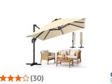 une photo d'un ensemble de jardin comprenant une table, des chaises et un parasol