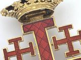 a red and gold cross with a crown on top