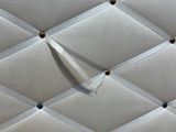 an image of a close up of a white quilted wall