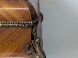 a wooden box on a glass table with a metal handle