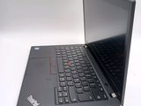 a laptop with a black keyboard on a white surface