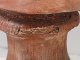 a close up of a wooden pedestal with a bowl on it