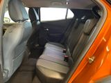 an orange car that is sitting in the back of the car