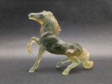 statue of a horse made of glass on a gray background
