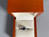 an image of a ring in a wooden box on a table