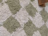 a cat that is laying on a rug on the floor