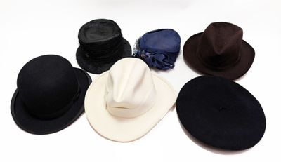 Plusieurs chapeaux sont disposés en cercle sur une surface blanche