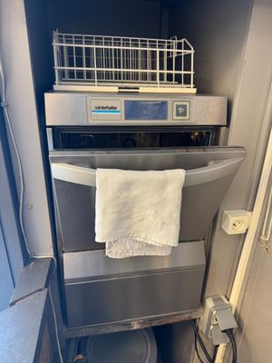 an image of a bathroom with a toilet and a dishwasher