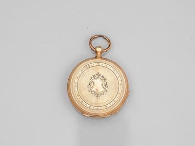 an antique gold pocket watch with a medallion on the face
