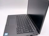 a laptop with a black keyboard sitting on a white surface