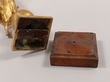 a small wooden box with a gold horse on it