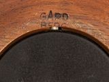 an image of a close up of a clock on a wooden surface
