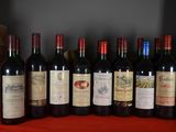 several bottles of wine are lined up on a table