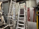 many ladders that are stacked up in a warehouse
