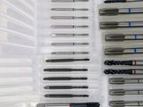 many different types of pens in a plastic container