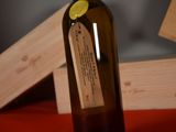 a bottle of wine sitting on a table next to a box