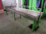 an image of a large metal sink in a green room