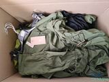 a cardboard box with a bunch of clothes inside of it