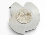 a close up of a piece of pottery with writing on it