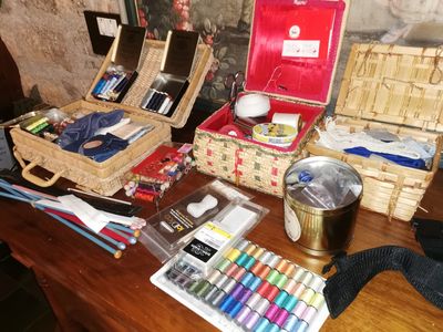 a wooden table topped with lots of crafting supplies
