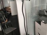 une photo d'une pièce avec une imprimante et une chaise