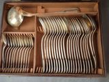a lot of silverware in a box with a spoon and a spoon
