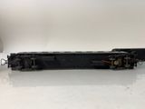 an old black train car sitting on top of a white table