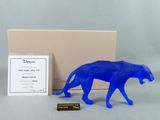an image of a blue figurine of a cheetah in front of a box