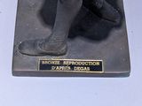 a statue of a little girl holding a tennis racquet