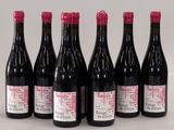 six bottles of wine are lined up in a row on a table