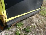 a close up of a yellow and black train on the tracks