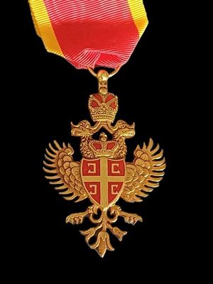 a gold medal with a red and yellow ribbon on it