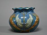 a blue vase with a gold decoration on it