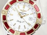 a close up of a red and white watch on a white surface