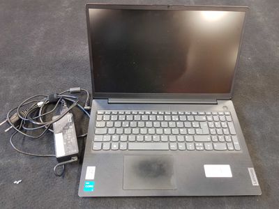 a laptop that is sitting on the floor with a charger