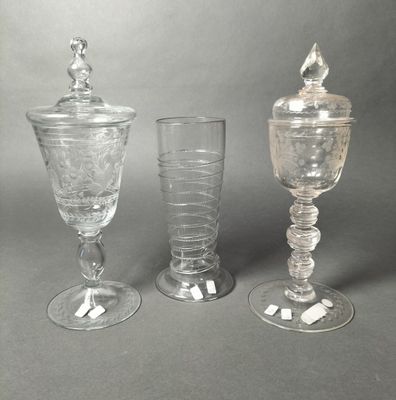 three glass goblets sitting next to each other on a table