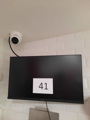 a picture of a television mounted on a wall in a bathroom