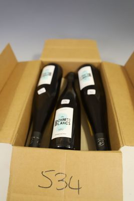 three bottles of wine in a box with a price tag