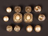 a group of gold and pearl buttons on a black surface