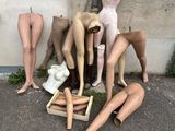 de nombreux mannequins assis par terre devant un immeuble